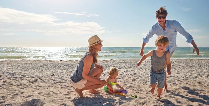 Eine Familie spielt am Strand