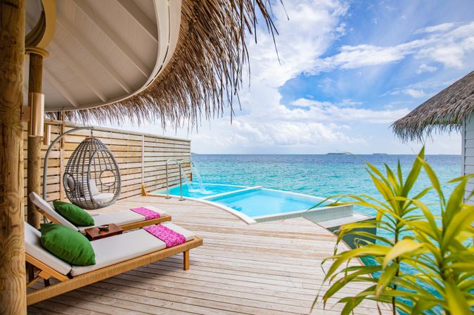 Eine Terrasse mit Privatpool und gemütlichen Liegen über dem Meer