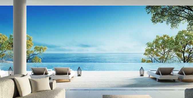 Moderne Terrasse mit Liegen und direktem Strandzugang