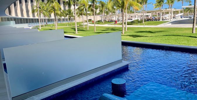 Ein Swim-up Pool mit Palmen im Hintergrund