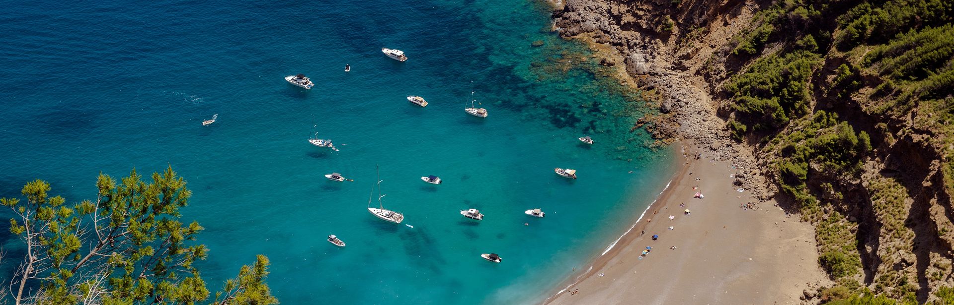 Eine Bucht mit Strand und einigen Schiffen im Meer