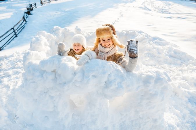 Zwei Kinder spielen im Schnee